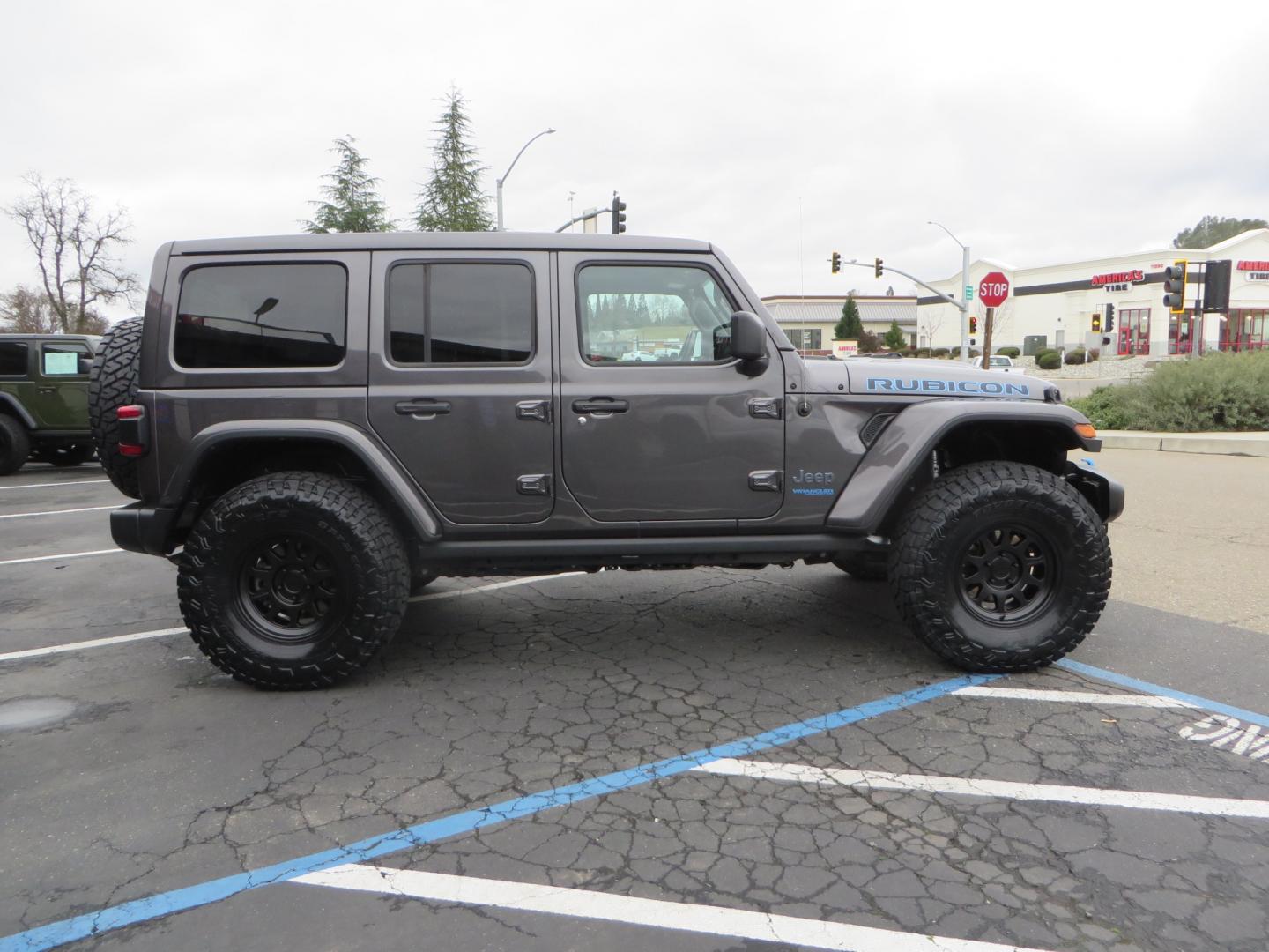 2021 CHARCOAL /BLACK Jeep Wrangler Unlimited Rubicon 4XE 4d SUV 4wd (1C4JJXR60MW) with an 2.0L L4 DOHC 16V TURBO engine, automatic transmission, located at 2630 Grass Valley Highway, Auburn, CA, 95603, (530) 508-5100, 38.937893, -121.095482 - 4XE Rubicon sitting on a Zone offroad suspension system, Fox shocks, 37" Toyo RT trail tires, 17" Method Race wheels, Teraflex Hd tire carrier, and Flat tow ready. - Photo#3